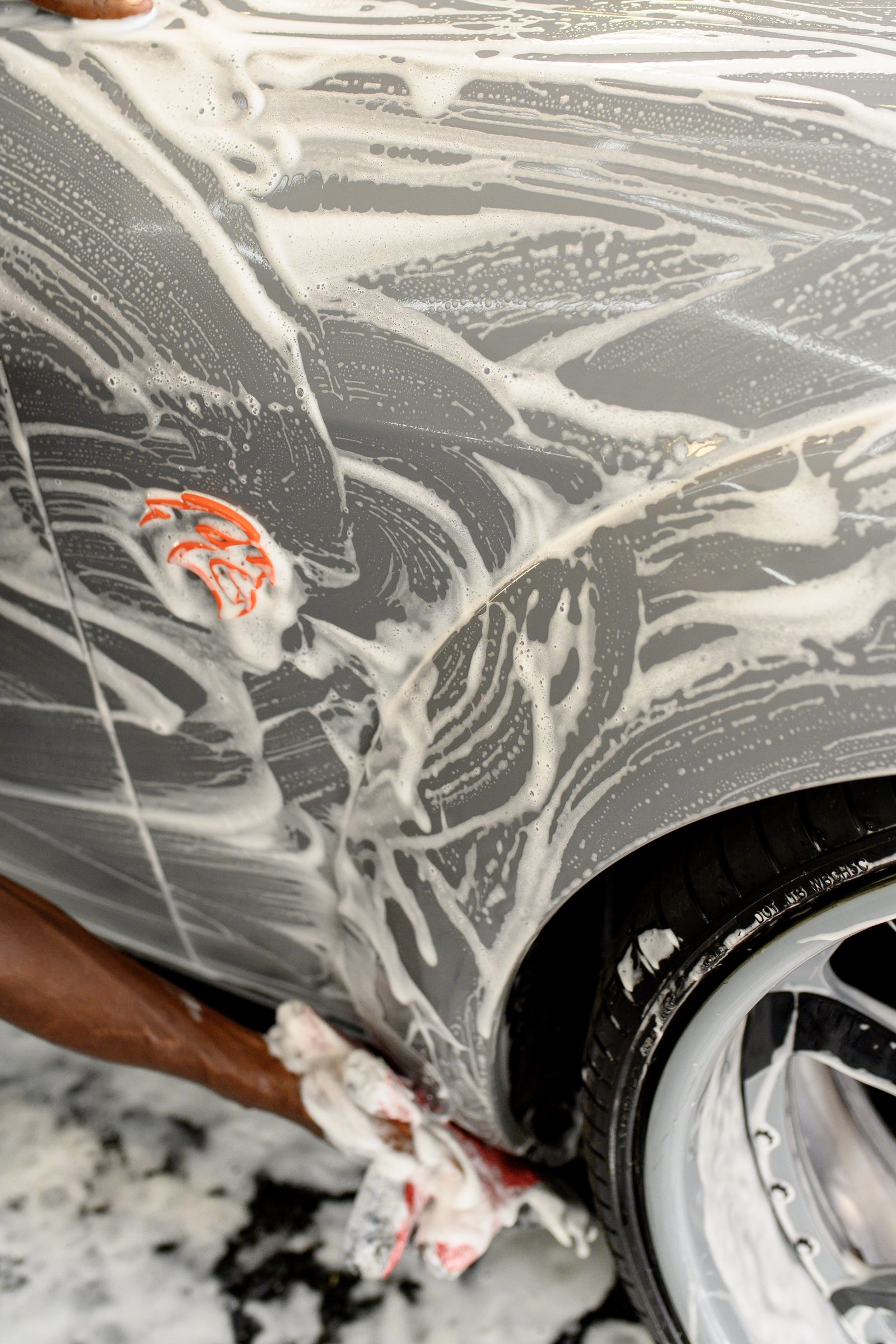 Foam covering the panel of a car during a detail