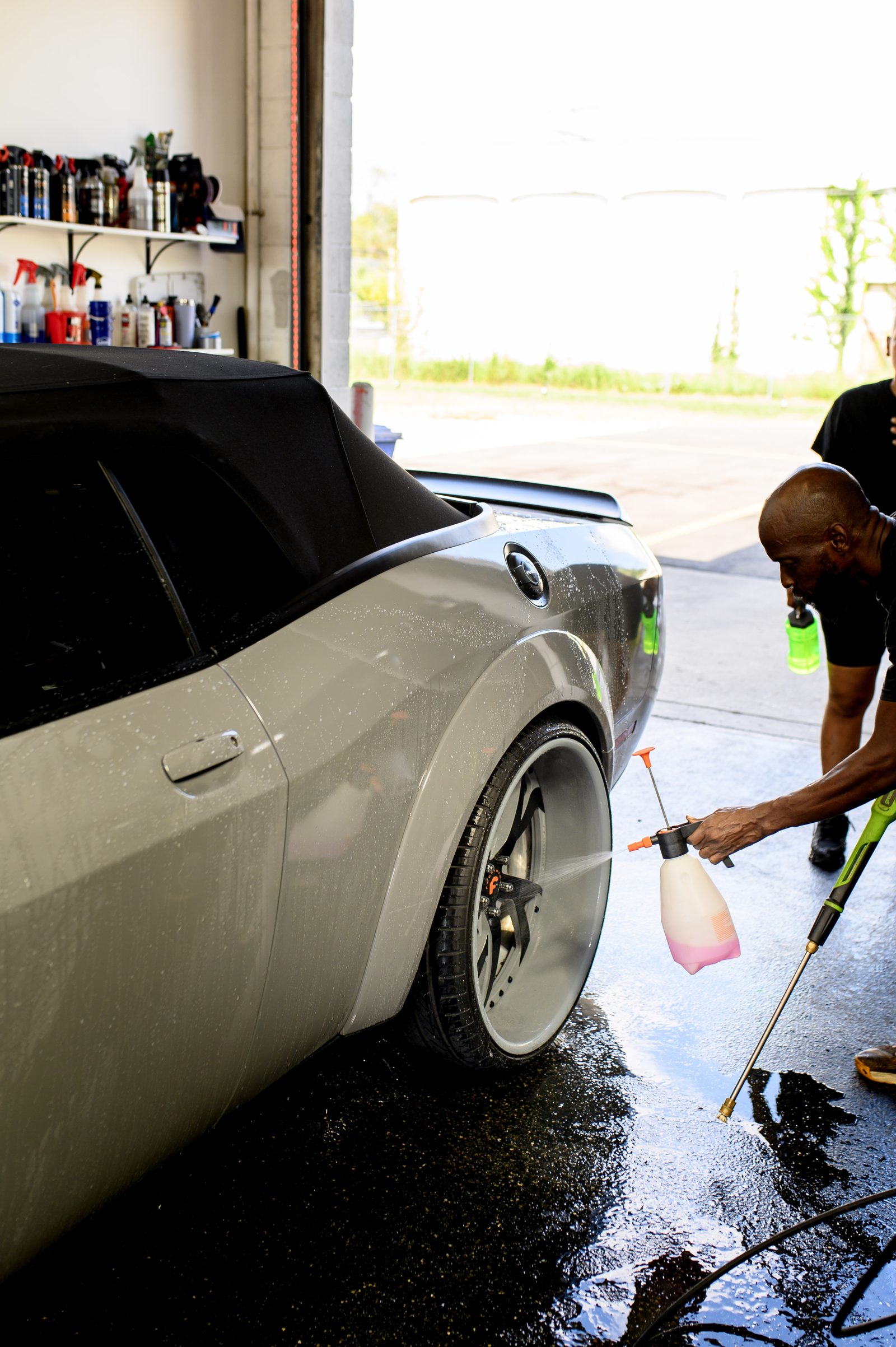 Wheel and tire being cleaned by hand at Columbus Undercoating